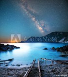 fascinating mystical magical landscape with a deach and boat racks at night in the light of the Milky Way stars Naklejkomania - zdjecie 1 - miniatura