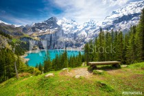 Amazing tourquise Oeschinnensee lake with waterfalls, wooden chalet and Swiss Alps, Berner Oberland, Switzerland Naklejkomania - zdjecie 1 - miniatura