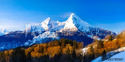Beautiful winter wonderland mountain scenery in the Alps with pilgrimage church of Maria Gern and famous Watzmann summit in the background, Berchtesgadener, Bavaria, Germany