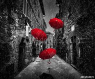 Umrbellas flying with wind and rain on dark street in an old Italian town in Tuscany, Italy Naklejkomania - zdjecie 1 - miniatura
