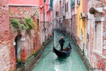 Venetian gondolier punting gondola through green canal waters of Venice Italy Naklejkomania - zdjecie 1 - miniatura