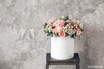 Beautiful tender bouquet of flowers in white box on gray ackground with space for text Naklejkomania - zdjecie 1 - miniatura