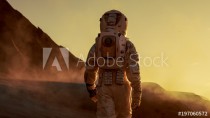 Shot of Astronaut Confidently Walking on Mars. Red Planet Covered in Gas and Smoke. Humans Overcoming Difficulties. Big Moment for the Human Race. Naklejkomania - zdjecie 1 - miniatura