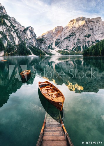 Boats and slip construction in Braies lake with crystal water in background of Seekofel mountain in Dolomites in morning, Italy Pragser Wildsee - zdjęcie 1