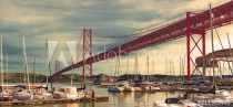 Bridge of April 25 in Lisbon.Cityscape of Lisbon and seaport. Entertainment and leisure in Portugal.Boats, sailboats and yachts in the port Naklejkomania - zdjecie 1 - miniatura