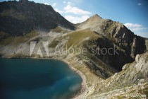 Landscape of highland lake high in the mountains of Dombai. Circus formed by a glacier with a deep lake and blue water Naklejkomania - zdjecie 1 - miniatura