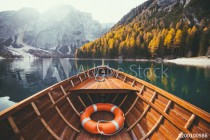 Traditional rowing boat on a lake in the Alps in fall Naklejkomania - zdjecie 1 - miniatura