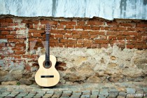 Spanish guitar on old wall, copy spaced. Naklejkomania - zdjecie 1 - miniatura