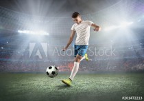 Soccer player on a football field in dynamic action at summer da Naklejkomania - zdjecie 1 - miniatura