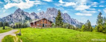 Idyllic landscape in the Alps with mountain chalet and green meadows Naklejkomania - zdjecie 1 - miniatura
