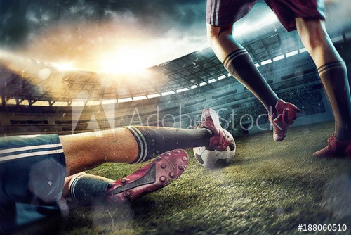 The soccer football players at the stadium in motion