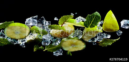 Mint, lime slices and ice on the glass table, bottom view.