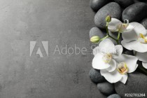 Flat lay composition with spa stones and orchid flowers on grey background. Space for text Naklejkomania - zdjecie 1 - miniatura