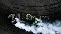 Aerial top view two cars drifting battle on race track, Two cars battle drift, Race cars view from above. Naklejkomania - zdjecie 1 - miniatura