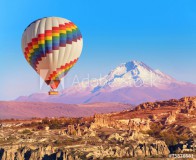 Balloon flying over rock landscape at Cappadocia Turkey Naklejkomania - zdjecie 1 - miniatura